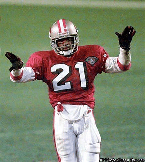 Cornerback Deion Sanders of the Dallas Cowboys prays while